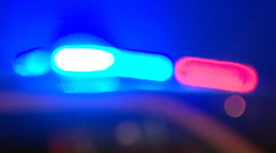 Police investigate a fatal rollover crash scene on a rural Minnesota highway