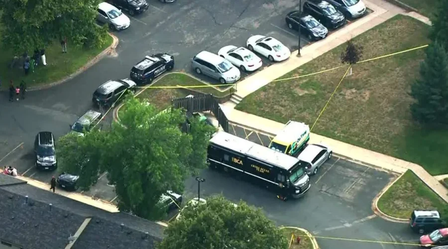 Police tape and emergency vehicles outside a home in Inver Grove Heights, Minnesota